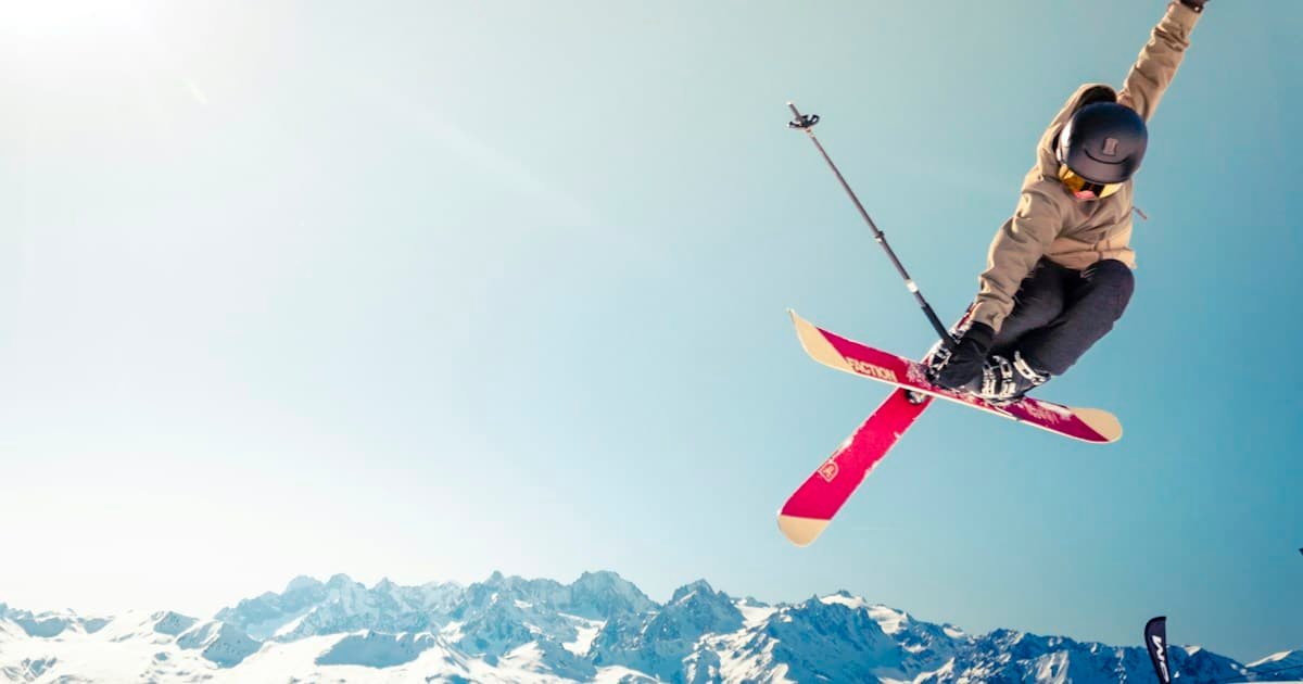Ski resort with snow-covered mountain slopes and skiers in Alpine landscape