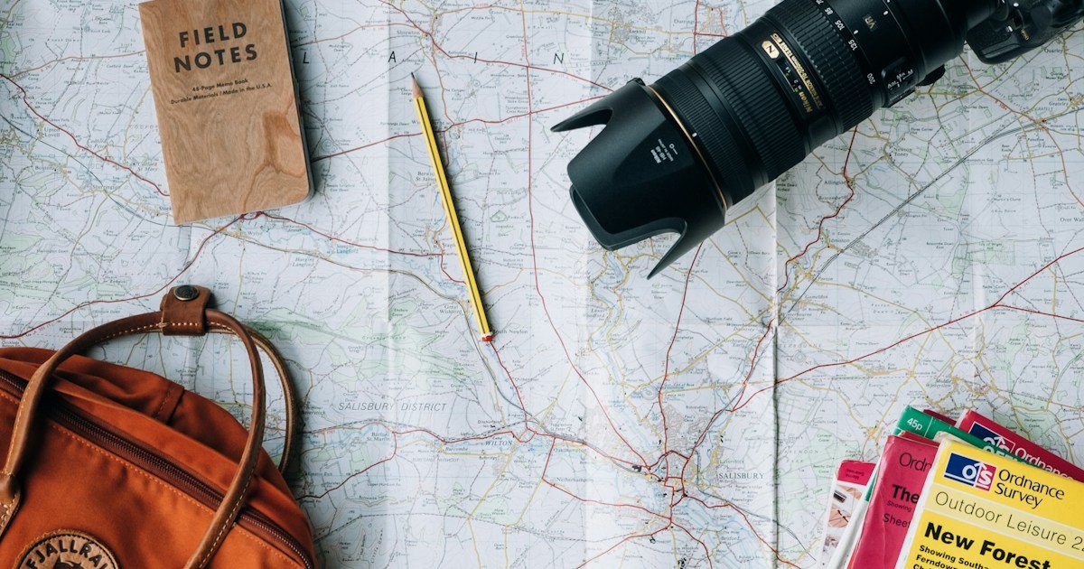 Solo traveler with backpack looking at map in foreign city with travel safety